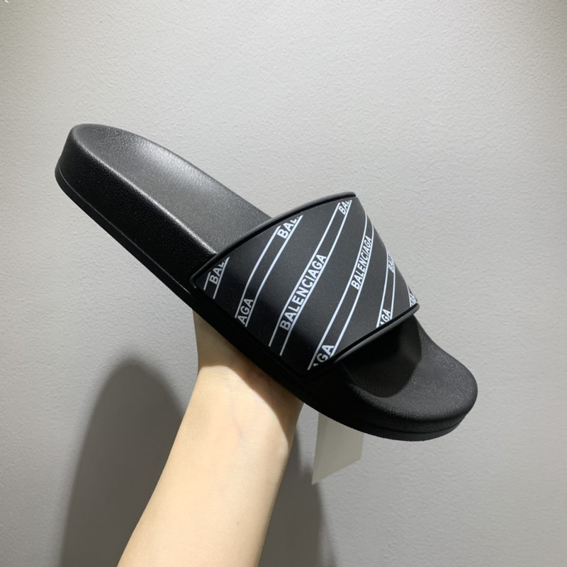 Ba*len*cia*ga black logo pool slides in grain rubber